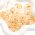 Irregular translucent amber acrylic beads in a white dish for jewelry making - Transparent Apricot