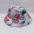 Close-up of tropical floral print bucket hat featuring pink hibiscus and cyan leaves - White Pink Red Cyan Floral