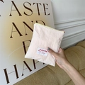 Detail of light pink pleated fabric cosmetic pouch with SOZAKKA label held in hand - Off-white (Vertical)