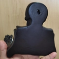 Detail view of the skull toilet paper holder back with mounting keyhole slot - Black