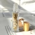 Essential oil glass roller bottle with natural amber crystal stones and a wooden cap - Rutilated Quartz Gold
