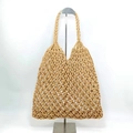 Detail of khaki woven cotton rope tote bag showing sturdy braided handles and mesh design - Camel