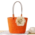 Orange handwoven straw bag with a large cream floral ornament and brown handles - Orange Red