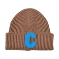 Close-up of ribbed knit beanie texture with a blue fuzzy letter C patch detail - Coffee & Blue