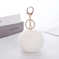 Detailed view of fluffy white faux rabbit fur pom pom with gold lobster clasp keychain - White