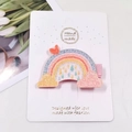 Close-up of glittery rainbow hair clip with heart detail on a white display card - Heart Rainbow Cloud