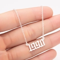 Macro detail of silver-finish stainless steel necklace with 1990 birth year pendant - 1990 / Steel