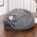 Close-up of gray wool beret with mesh veil, bow detail and elegant pearl accents - M (56-58cm) / Gray