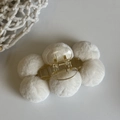Detail of white plush pom-pom hair claw clip with transparent base and gold spring - White