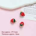 Detailed close-up of 8x11mm strawberry charms with red enamel and gold plating for DIY jewelry - Strawberry (8x11mm)
