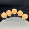 Five apricot clay balloon cake toppers on a white cake with gold pearl beads - Single Piece / Champagne (Skin Tone)