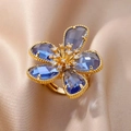 Elegant gold flower ring featuring blue crystal petals and cubic zirconia accents - Gold Blue Flower (G3014442)