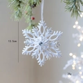 White flocked snowflake Christmas ornament with blue gem center and hanging ribbon - Snowflake