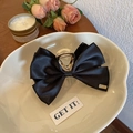 Elegant black satin bow hair claw clip with golden metal accents in a minimalist style - Bow Claw Clip / Black