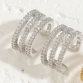 Macro detail of silver layered ear cuff with brilliant zircon pavé on stone surface - Three-layer Zircon Ear Cuff / Platinum Color
