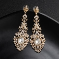 Macro view of baroque gold rhinestone earrings featuring hollow patterns and pear-shaped drop - Gold (J3046G)
