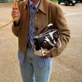 Women's brown suede button jacket paired with a cow-print branded crossbody bag - S / Brown