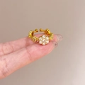 Adjustable gold plated flower ring with seven sparkling white cubic zirconia stones - Flower Milgrain
