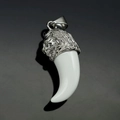 Close-up of a stainless steel lion head pendant with a white resin fang on a dark surface - Steel White Tooth (No Chain)
