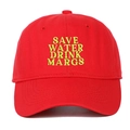 Detailed close-up of neon yellow Save Water Drink Margs embroidery on a red baseball cap - Red