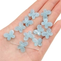 Light blue gradient butterfly acrylic beads displayed on hand for DIY jewelry making - Lake Blue