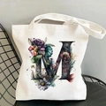 Close-up of canvas tote bag with floral letter M watercolor print on a chair - Letter M / 35*40cm