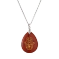 Detailed macro view of a teardrop red stone pendant with golden Hamsa Hand engraving - Red Stone/Stainless Steel Chain