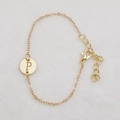 Golden chain bracelet featuring a hollow round pendant with letter P engraving - Gold P