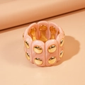 Macro detail of pink marble resin bracelet with gold metallic studs and stretch band - Pink