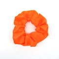 Vibrant orange satin scrunchie hair tie with smooth fabric texture on white background - Orange