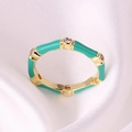 Macro detail of gold bamboo ring with teal enamel glaze and small sparkling zircons - Adjustable Open / Light Green