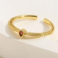Macro shot of gold adjustable ring featuring a red heart zircon and beaded band detail - Adjustable Open / Water Drop Red Corundum