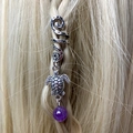 Close-up of a silver spiral hair ring with a turtle charm and purple amethyst bead - Turtle Purple Bead