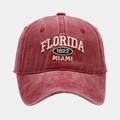 Close-up of Florida 1822 Miami embroidery on a vintage washed burgundy cotton baseball cap - Adjustable / Burgundy