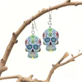 Macro detail of sugar skull earrings with colorful floral relief on dried branch - Light Blue with Red Yellow Green Pattern
