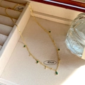 Detail of gold necklace with green drop gemstones in a velvet box with length markings - Gold Vintage Multi-Gemstone Tassel Necklace