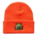 Macro shot of orange ribbed knit beanie showing detailed green frog embroidery and texture - Frog Embroidery Knitted Beanie / Orange Red
