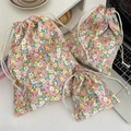 Three-piece floral canvas drawstring storage bags for skincare and travel accessories - Orange Flower