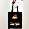 Detail of black Merry Christmas canvas tote bag shown being held by a model - Style 07-We Wish You Merry Christmas