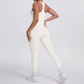Detail view of high-waist cream yoga leggings showing ergonomic stitching and body-shaping fit - S / Top And Bottom / Light Ivory