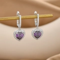 Detail shot of heart-shaped earrings with purple gems and pavé zircon on silver hardware - Silver Purple