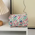 Quilted floral makeup bag in beige with delicate pink and blue flowers on a desk - Quilted Square Nostalgic Flowers
