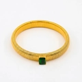 Macro detail of gold-tone Tubogas snake bracelet with emerald green zircon centerpiece - 10mm Width x 18cm Circumference / Emerald