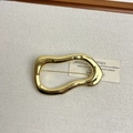 Detailed shot of golden irregular hollow brooch with high-gloss metallic finish on fabric - 22 Gold Irregular Ring (Z-3946)
