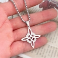 Celtic knot pendant necklace in silver stainless steel, shown in hand for scale - Steel Color with Pearl Chain