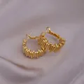 Elegant gold hoop earrings with vertical stripe texture on a purple silk background - Vertical Texture Hoop / E-073---Gold