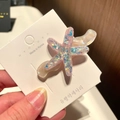 Detailed view of a pink glitter starfish hair clip made of translucent resin material - 9# Wavy Starfish - Pink