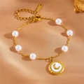 Elegant gold chain bracelet featuring white pearls and a crescent moon shell pendant - White Shell Moon Bracelet