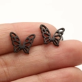 Black butterfly stud earrings with intricate hollow wings in matte stainless steel - 671 Matte Hollow Butterfly / Black