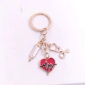 Detail of gold medical keychain with heart, syringe, and stethoscope charms - Style 9 (Gold ECG Heart Shape)